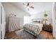 Bright bedroom featuring a ceiling fan, neutral walls, and warm wood-look flooring at 4765 E Charleston Ave, Phoenix, AZ 85032