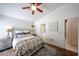 Cozy bedroom with ceiling fan, an ensuite bathroom and a sliding door for privacy at 4765 E Charleston Ave, Phoenix, AZ 85032