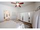 Bright bedroom with ceiling fan features an ensuite bath and mirrored wardrobe sliding doors at 4765 E Charleston Ave, Phoenix, AZ 85032
