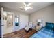 Bedroom featuring wood floors, a chair and access to other rooms at 4765 E Charleston Ave, Phoenix, AZ 85032