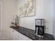 Coffee bar with a granite countertop and white cabinets underneath at 4765 E Charleston Ave, Phoenix, AZ 85032