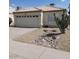 Well-maintained home exterior with a two-car garage, desert landscaping, and inviting curb appeal at 4765 E Charleston Ave, Phoenix, AZ 85032