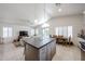 Bright open kitchen with island, eat-in area, and stainless appliances blends seamlessly into the living room at 4765 E Charleston Ave, Phoenix, AZ 85032