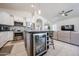 Modern kitchen with gray island, stainless appliances, wine cooler, and open access to the living area at 4765 E Charleston Ave, Phoenix, AZ 85032