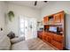 Home office featuring a built-in desk, shelving, sofa, and French door entry at 4765 E Charleston Ave, Phoenix, AZ 85032