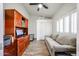 Home office featuring a built-in desk, shelving, sofa, and ample storage space at 4765 E Charleston Ave, Phoenix, AZ 85032