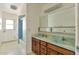 Well-lit bathroom with a double sink vanity with storage and a walk-in shower that leads to the exterior at 504 N Emerson --, Mesa, AZ 85201