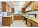 Functional kitchen with a window view, wooden cabinets, and appliances at 504 N Emerson --, Mesa, AZ 85201