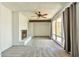 Bright living room features a cozy fireplace, ceiling fan, and a large picture window at 504 N Emerson --, Mesa, AZ 85201