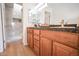 Bathroom featuring double sinks, granite countertops and a glass door shower at 5122 E Shea Blvd # 1043, Scottsdale, AZ 85254