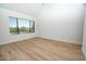 Bedroom featuring light wood flooring and a large window with outdoor view at 5122 E Shea Blvd # 1043, Scottsdale, AZ 85254
