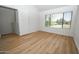 Bedroom featuring light wood flooring, a closet and a large window with outdoor view at 5122 E Shea Blvd # 1043, Scottsdale, AZ 85254
