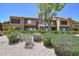 Beautiful exterior of a multi-story building surrounded by manicured landscaping, rocks and a clear blue sky at 5122 E Shea Blvd # 1043, Scottsdale, AZ 85254