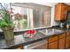 Well-lit kitchen boasts stainless steel appliances, granite countertops, and a view through window blinds at 5122 E Shea Blvd # 1043, Scottsdale, AZ 85254