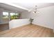 Bright living room with light wood floors, white walls, chandelier and outdoor view at 5122 E Shea Blvd # 1043, Scottsdale, AZ 85254
