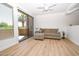 Bright living room features wood floors, light-colored sofa, and sliding doors to the patio at 5122 E Shea Blvd # 1043, Scottsdale, AZ 85254