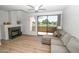 Bright living room with modern fireplace, wood floors, light-colored sofa, and sliding doors to the patio at 5122 E Shea Blvd # 1043, Scottsdale, AZ 85254