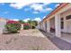Backyard showcasing desert landscaping, patio and vibrant plants at 5322 W Wethersfield Dr, Glendale, AZ 85304