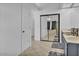 Bright bathroom features double sinks, tiled floors, and a large mirrored closet with a glimpse into a sunny atrium at 5322 W Wethersfield Dr, Glendale, AZ 85304