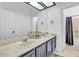 Bathroom featuring a double vanity, large mirror, and great lighting at 5322 W Wethersfield Dr, Glendale, AZ 85304