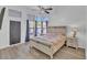 Main bedroom featuring wood floors, ensuite bath, and ample natural light at 5322 W Wethersfield Dr, Glendale, AZ 85304