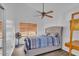 Comfortable bedroom with ceiling fan, bedside table, and modern bed frame at 5322 W Wethersfield Dr, Glendale, AZ 85304