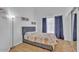 Cozy bedroom with hardwood floors, closet, and a large window at 5322 W Wethersfield Dr, Glendale, AZ 85304