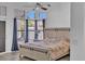 Cozy main bedroom has wood floors, a ceiling fan, and a door to the backyard at 5322 W Wethersfield Dr, Glendale, AZ 85304