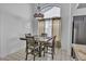 Dining area featuring tile floors, a chandelier, and large windows providing ample natural light at 5322 W Wethersfield Dr, Glendale, AZ 85304