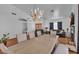 Dining area featuring hardwood floors, large windows, chandelier and is adjacent to the living room at 5322 W Wethersfield Dr, Glendale, AZ 85304