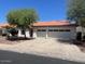 Home showcasing a spacious driveway, a two-car garage and desert landscaping at 5322 W Wethersfield Dr, Glendale, AZ 85304