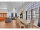 Spacious open-plan design with hardwood floors, fireplace, large windows, and an adjacent dining area at 5322 W Wethersfield Dr, Glendale, AZ 85304