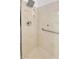 Close-up of the accessible shower with a grab bar and modern shower head at 5322 W Wethersfield Dr, Glendale, AZ 85304