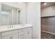 Bathroom with double sink vanity, chrome fixtures and a walk-in closet at 5859 E Covey Ln, Phoenix, AZ 85054