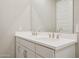 Bright bathroom with a double vanity, white countertop and chrome faucets at 5859 E Covey Ln, Phoenix, AZ 85054