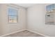 Bedroom features gray carpet, neutral walls, and two windows with blinds at 5859 E Covey Ln, Phoenix, AZ 85054