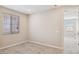 A carpeted bedroom with a window, neutral walls, and ample outlets at 5859 E Covey Ln, Phoenix, AZ 85054