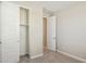 Bedroom featuring a door and sliding closet, with gray carpet and neutral walls at 5859 E Covey Ln, Phoenix, AZ 85054