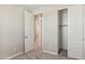 Bedroom featuring a door and sliding closet, with gray carpet and neutral walls at 5859 E Covey Ln, Phoenix, AZ 85054