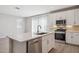 Bright open-concept kitchen featuring an island, stainless appliances, and large windows at 5859 E Covey Ln, Phoenix, AZ 85054