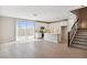 Bright open-concept kitchen featuring white cabinets, an island, and a sliding glass door at 5859 E Covey Ln, Phoenix, AZ 85054