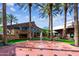 Picturesque outdoor plaza with a central water feature, fireplace, palm trees, and inviting seating areas at 5859 E Covey Ln, Phoenix, AZ 85054