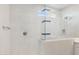 Modern shower featuring marble-look tile, a glass enclosure, and a bright window at 5859 E Covey Ln, Phoenix, AZ 85054