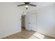 Well-lit bedroom boasts wood-look floors, a ceiling fan, and a closet at 6601 N 46Th Ln, Glendale, AZ 85301