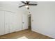 Bright bedroom features wood-look floors, a ceiling fan, and a closet for ample storage at 6601 N 46Th Ln, Glendale, AZ 85301