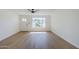 Comfortable living room featuring wood floors, a ceiling fan, and ample natural light at 6601 N 46Th Ln, Glendale, AZ 85301
