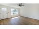 Cozy living room with wood floors, a front door, and a view of the well-manicured yard at 6601 N 46Th Ln, Glendale, AZ 85301