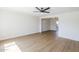 Bright living room featuring wood floors, a modern ceiling fan, and an open layout at 6601 N 46Th Ln, Glendale, AZ 85301