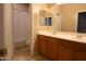 A bathroom features a shower and a double sink vanity with a tile floor at 6619 W Cordia Ln, Phoenix, AZ 85083