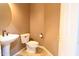 Powder room with pedestal sink, decorative mirror, tiled floors and a modern toilet at 6619 W Cordia Ln, Phoenix, AZ 85083